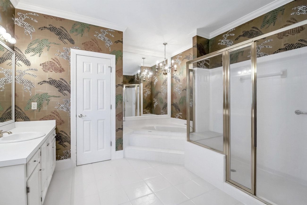 Original bath with corner garden tub and framed shower enclosure