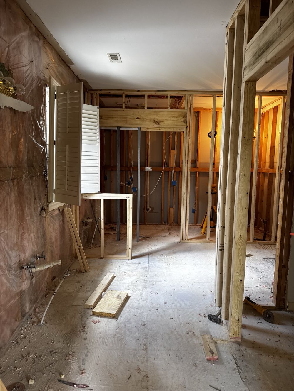 The same wall mid-construction, with new stud walls and a structural header